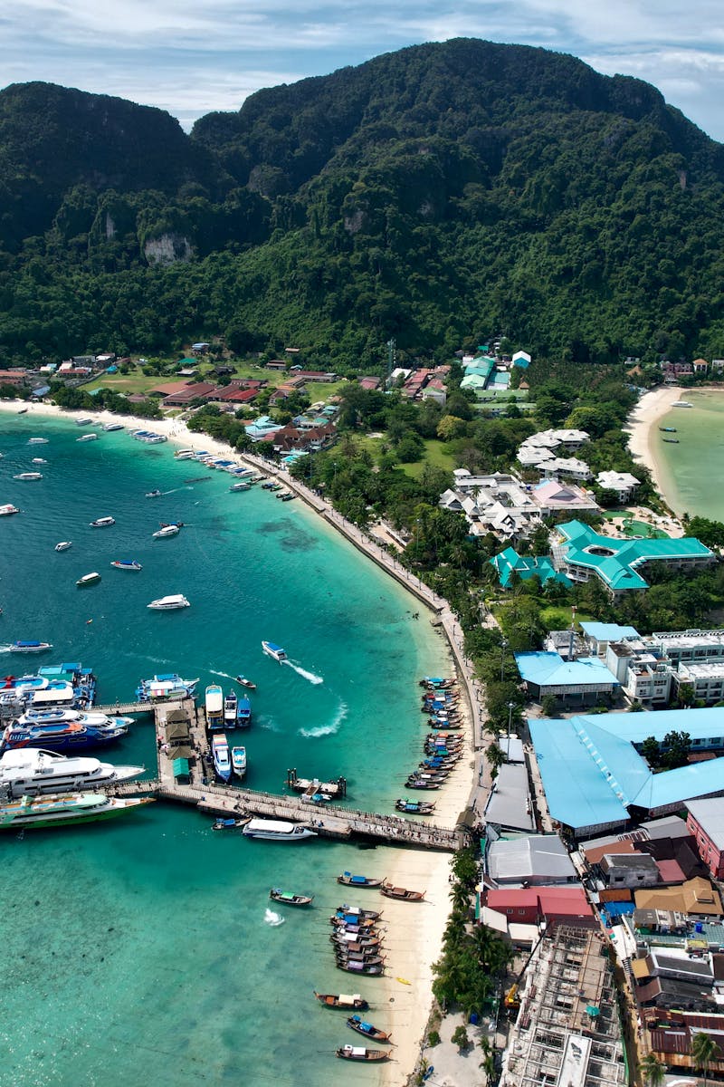 Stunning aerial shot of Tonsai Village, Phi Phi Islands with vibrant turquoise waters and lush hills.